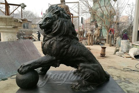 Bronze foundry casting lion holding the ball for public decor