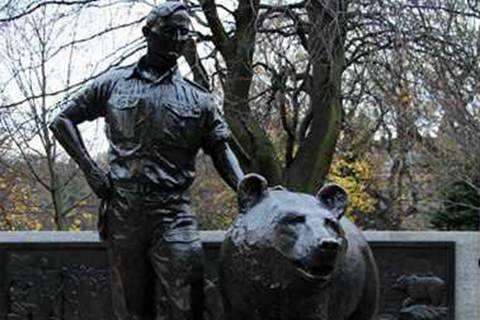 bronze-bear-with-people-sculpture